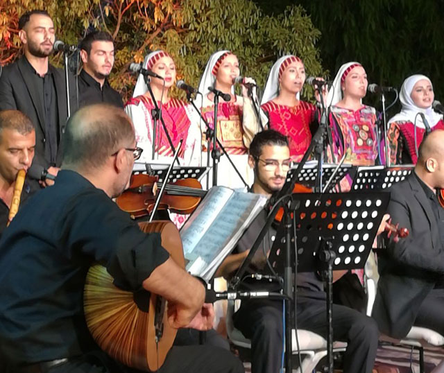 Al Hannouneh choir and musical band performs at the archaelogical site of Darat Al Funun on Saturday (Photo courtesy of Al Hannouneh)