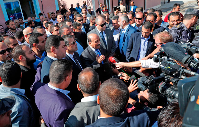 Palestinian Authority Minister Mufeed Al Husayna (centre) gives a press conference at the northern entrance of the Gaza Strip just after the Israeli-controlled Erez crossing, in Beit Hanun, on Wednesday (AFP photo)