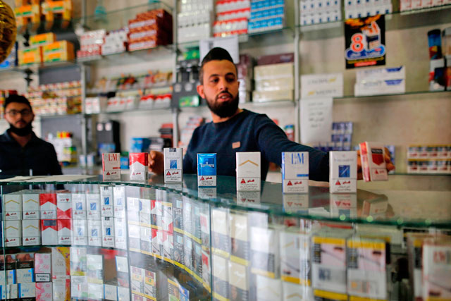 A Palestinian vendor sells cigarettes at his shope in Gaza City on Monday (AFP photo)