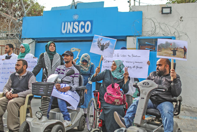 A group of disabled Palestinians holding banners and posters stage a protest in front of UNESCO office, for 29-year-old disabled Palestinian Abraham Abu Sureyya who was martyred by the Israeli army during protests for Jerusalem in Gaza, on Thursday (Anadolu Agency photo)