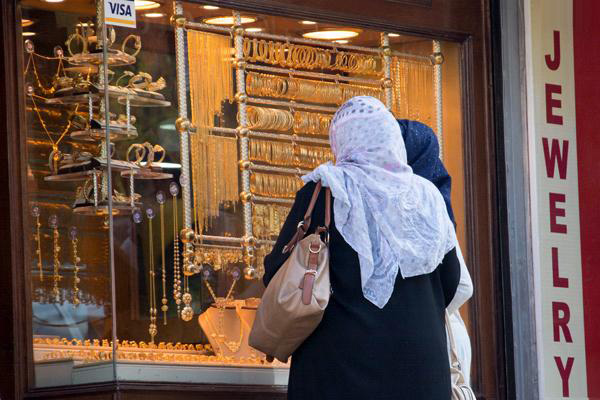 Jordanian women look at gold jewellery displayed at a shop in Amman recently  (Photo by Amjad Ghsoun)