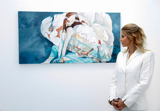 Rana Sunaij  poses next to one of her paintings at the Harmony exhibition at the Wadi Finan Art Gallery (Photo courtesy of Rana Sunaij)