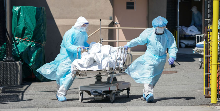 In this file photo taken on April 6, bodies are moved to a refrigeration truck serving as a temporary morgue at Wyckoff Hospital in the Borough of Brooklyn in New York (AFP photo)
