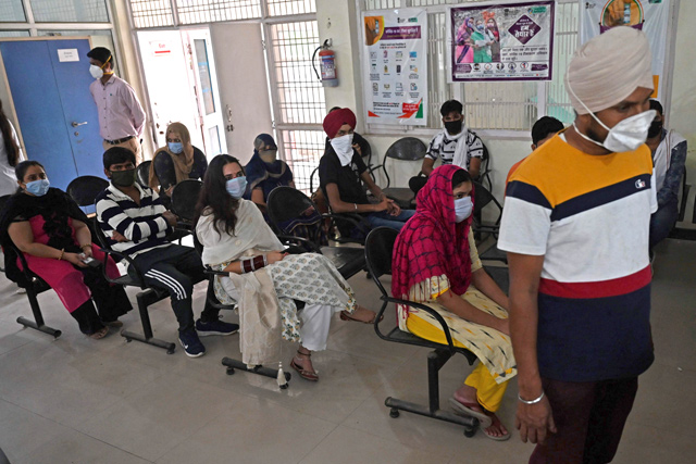 In this photo taken on June 1,  people sit in an observation area after getting their dose of the Covishield vaccine against the COVID-19 coronavirus during a vaccination drive being held at a community health centre in Kalwa village on the outskirts of Jind (AFP photo)