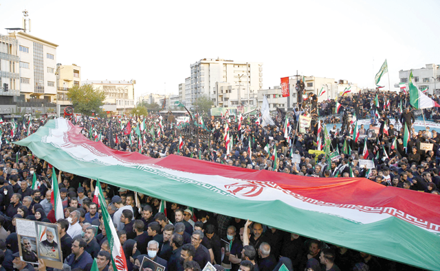Iranian pro-government protesters wave their national flag during a rally against the recent anti-government protests in Tehran on Sunday (AFP photo)