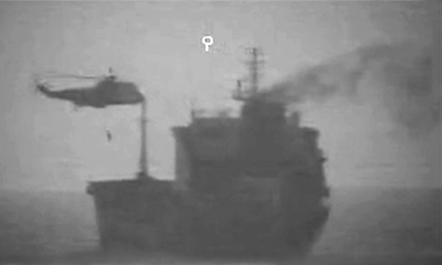 This handout image released by the US Central Command on Thursday reportedly shows Iranian forces boarding a tanker in international waters in the Gulf of Oman using a helicopter and two ships to take over the vessel for several hours, according to US officials (AFP photo)
