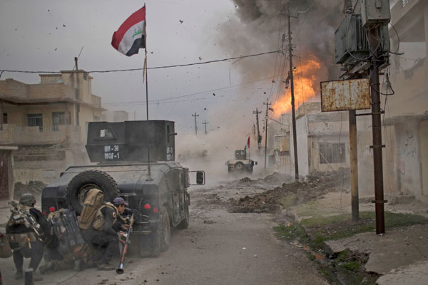 In this November 16 file photo, a car bomb explodes next to Iraqi special forces armoured vehicles as they advance towards Daesh held territory in Mosul, Iraq (AP photo)