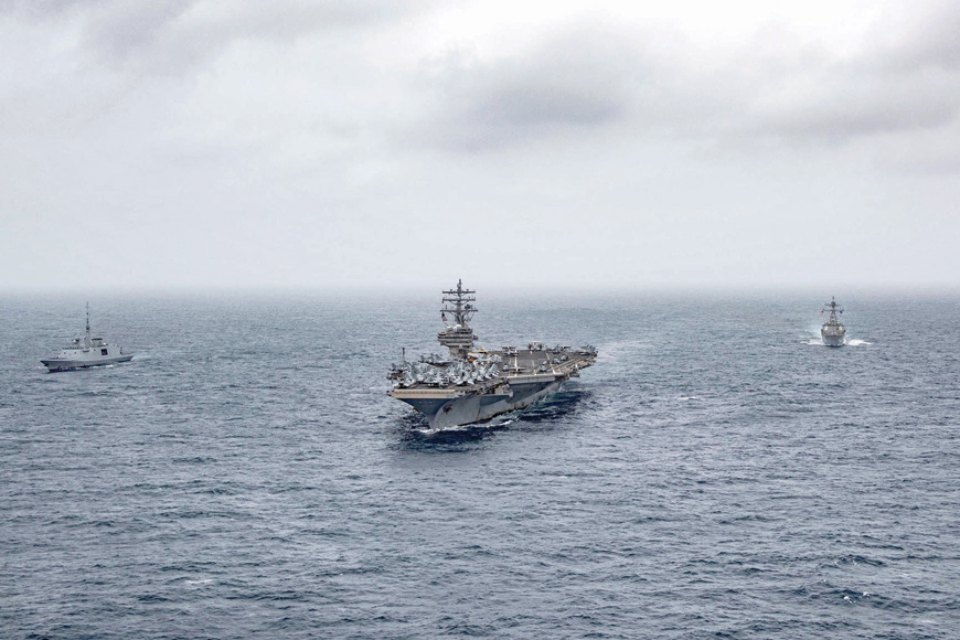 This handout photo courtesy of US navy and made available on July 24, shows (left to right) French navy frigate FS Languedoc (D653), aircraft carrier USS Ronald Reagan (CVN 76), and guided-missile destroyer USS Halsey (DDG 97) steaming in formation in the Arabian Sea (AFP photo)