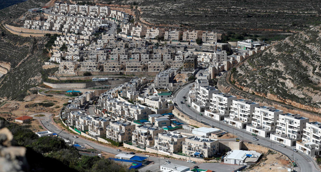 This file photo taken on January 21, shows ongoing construction work in the Israeli settlement of Givat Zeev, near the Palestinian city of Ramallah in the occupied West Bank (AFP photo)