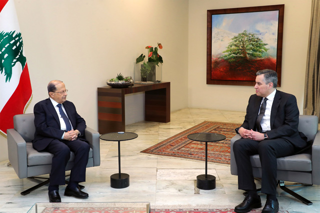 A handout picture released by the Lebanese photo agency Dalati and Nohra on Saturday, shows Lebanon's President Michel Aoun (left) meeting with prime minister-designate Mustapha Adib, at the presidential palace in Baabda, east of the capital Beirut (AFP photo)