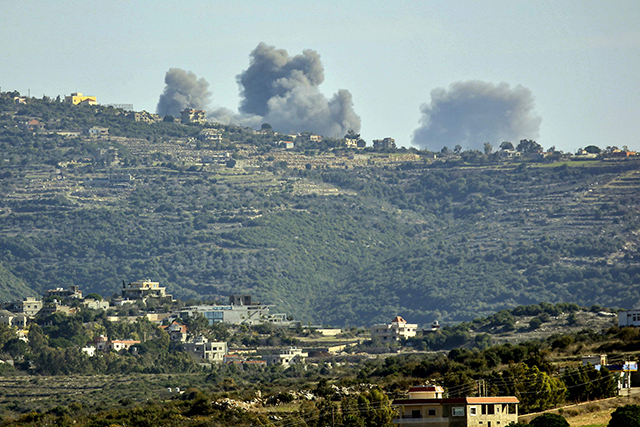 This photo taken from southern Lebanon shows smoke rising after an Israeli strike between the villages of Qaouzah and Ramia near the border with Israel on Monday (AFP photo)