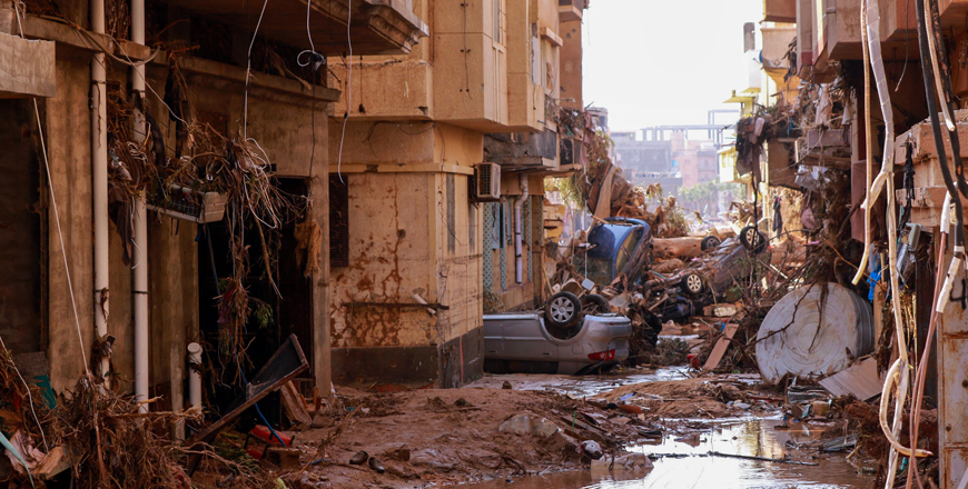 Overturned cars lay among other debris caused by flash floods in Derna, eastern Libya, on Monday (AFP photo)