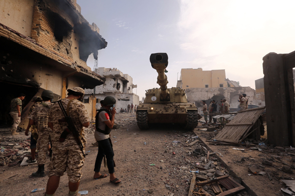 Members of the forces loyal to Libya’s UN-backed Government of National Accord gather in the coastal city of Sirte, east of the capital Tripoli, during their military operation to clear Daesh terror group militants from the city, on Friday (AFP photo)