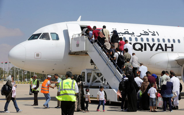 Passengers board a flight at Benina airport, east of Benghazi, Libya, Saturday (Reuters photo)