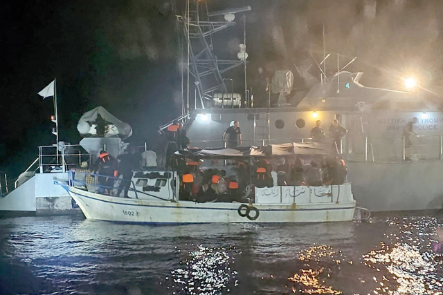 A handout obtained from the Cypriot government's Joint Rescue Coordination Centre on Tuesday shows a fishing boat with migrants on board and Arabic writing on its hull after sending a distress signal while sailing off Cape Greco in southeastern Cyprus the night before (AFP photo)