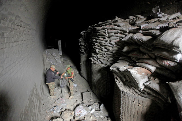 Members of the Rapid Response Forces inspect a tunnel that was used by the Daesh militants as an underground training camp in the hillside overlooking Mosul, Iraq, on Saturday (Reuters photo)