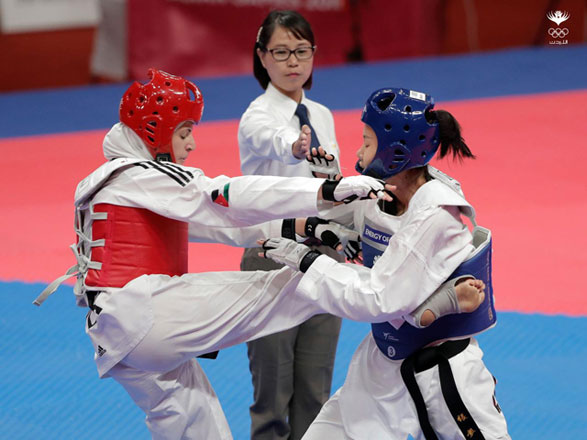 Juliana Al Sadiq (left), seen here in action, won gold medal in the 18th Asian Games held in Indonesia recently (Photo courtesy of Jordan Olympic Committee)