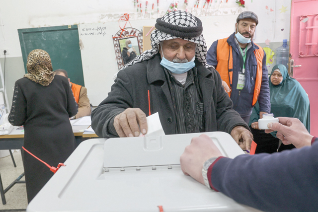 An elderly Palestinian man casts his ballot as he votes in the local elections in Beit Furik, east of the West Bank city of Nablus, on Saturday (AFP photo)