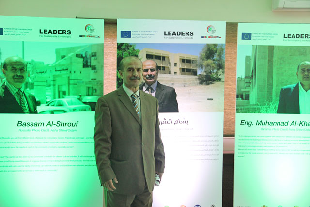 Bassam Al Shrouf, a beneficiary from the LEADERS initiative, poses in front of his success story poster at Queen Zein Al Sharaf Institute for Development, on Monday (Photo by Camille Dupire)