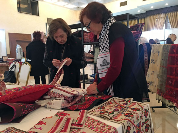 In this photo taken on Thursday, women browse through traditional Palestinian wares   (Photo by Muath Freij)
