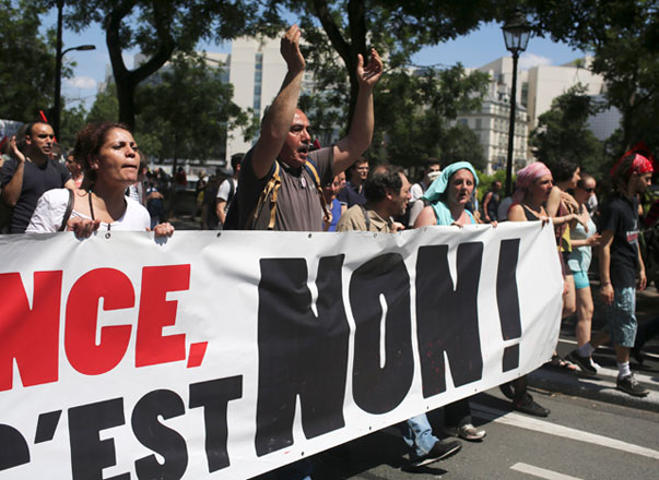 Demonstrators hold a banner reading ‘No’ during a demonstration in Paris, Thursday (AP photo)