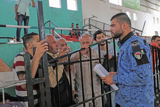 Palestinians wait to travel to Egypt through the Rafah border crossing, in the southern Gaza Strip on Friday (AFP photo)
