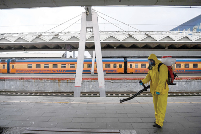 A serviceman of Russia's Emergencies Ministry wearing protective gear disinfects Moscow's Leningradsky railway station on Tuesday, amid the ongoing coronavirus pandemic (AFP photo)