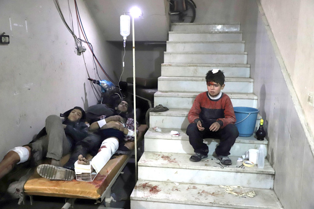 Wounded Syrians wait to receive treatment at a makeshift hospital in Kafr Batna in the besieged Eastern Ghouta region, on the outskirts of the capital Damascus, following Syrian government bombardments on Wednesday (AFP photo)