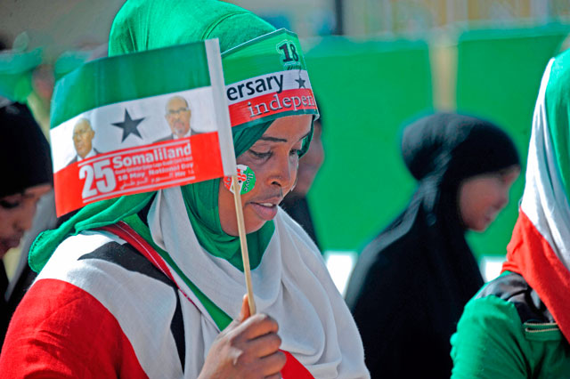This file photo taken on May 18, 2016, shows a woman holding a flag as soldiers and other military personnel of Somalia's breakaway territory of Somaliland march past during an independence day celebration parade in the capital, Hargeisa (AFP photo)