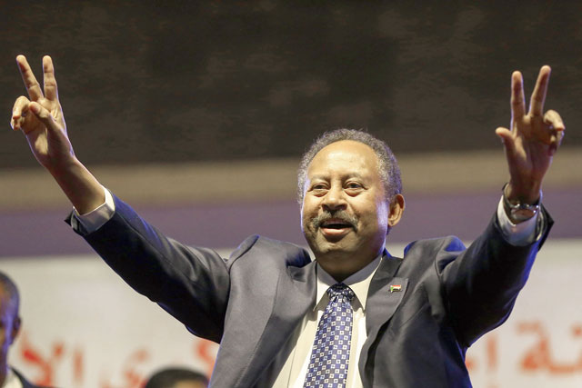 This file photo taken on December 25, 2019 shows Sudanese Prime Minister Abdullah Hamdock flashing the victory sign during a ceremony marking the first anniversary of the uprising that toppled Omar Al Bashir (AFP photo)