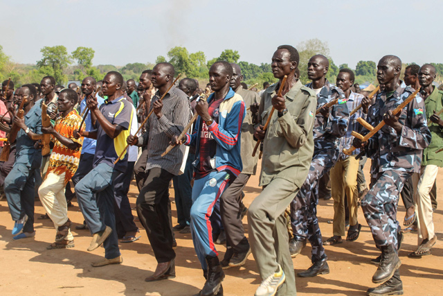 Police trainees, former soldiers of government and rebel groups, attend their training session with handmade wooden rifles or sticks and in civilian clothes at the unified training centre in Rejaf on March 25 (AFP photo)