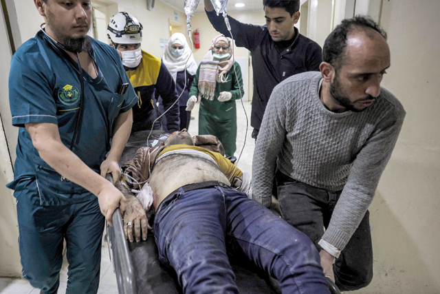 An injured man is rushed to receive medical care in the aftermath of reported bombardment by Syrian government forces, at a hospital in the rebel-held city of Idlib in northwestern Syria on Saturday (AFP photo)