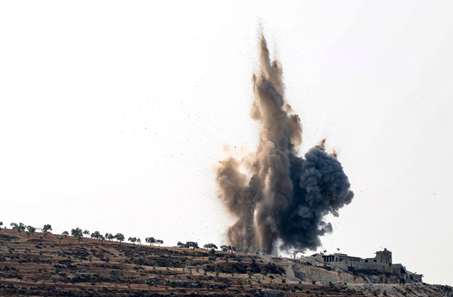 A plume of heavy smoke rises above a hill, during an air strike by pro-Syrian army forces on the outskirts of the town of Salwah in the rebel-held northern countryside of Syria's Idlib province on Saturday (AFP photo)