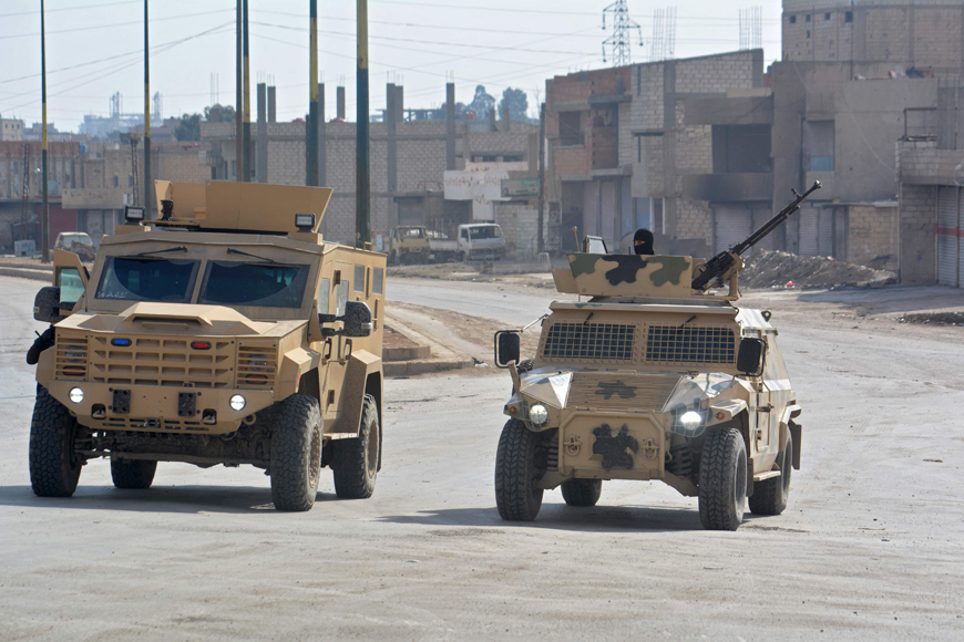  Syrian Democratic Forces patrol a street in the northern Syrian city of Hasakeh on Sunday (AFP photo)