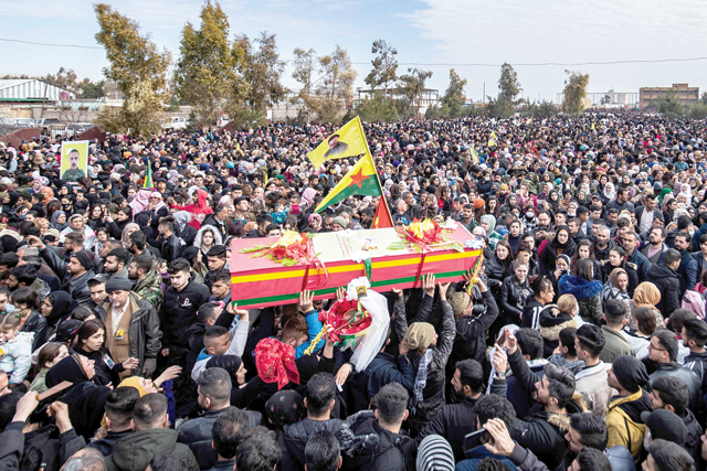 People take part in a funeral in the Kurdish-majority city of Qamishli in Syria's northeastern Hasakeh province on Wednesday, for Syrian Democratic Forces  fighters killed in clashes during a jailbreak attempt by the Daesh terror group at the Ghwayran prison in the province (AFP photo)