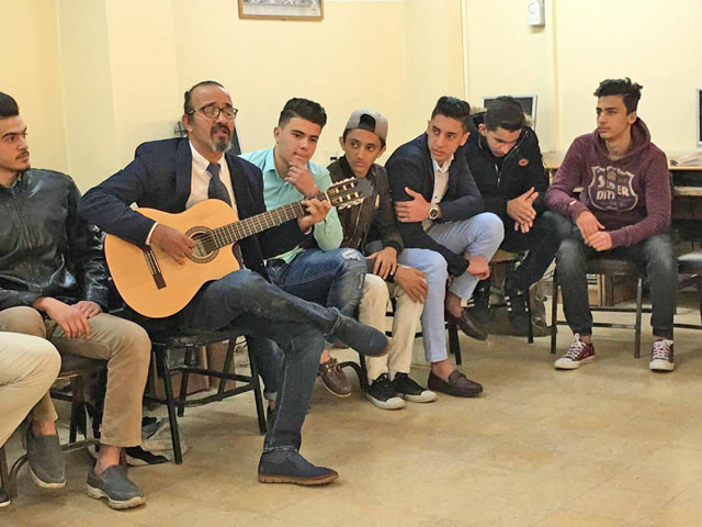 Physics teacher Mohammad Shbool uses creative teaching techniques to help his students more easily understand the subject (Photo by Muath Freij)