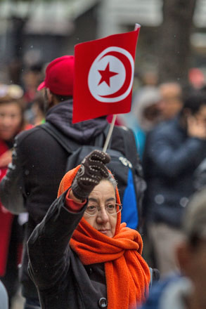 A woman holds a flag during a demonstration against terrorism and those involved in such activities at the Habib Bourguiba street in Tunis, Tunisia, on Sunday. Hundreds of Tunisians march against those returning to the country who were involved in terror activities in crisis and war zones (Anadolu photo)