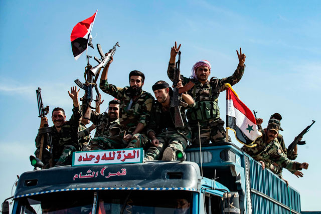 Syrian forces arrive in the town of Tall Tamr, not far from the flashpoint Kurdish Syrian town of Ras Al Ain on the border with Turkey, which has been a key target of Turkish forces and their proxies since they launched their military assault, on Tuesday (AFP photo)