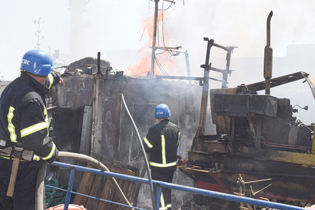 A handout image made available by the Odessa City Council Telegram channel on Saturday, shows Ukrainian firefighters battling a fire on a boat burning in the port of Odessa after missiles hit the port on Saturday (AFP photo)