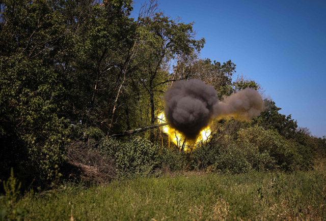 Ukrainian servicemen fire with a Polish 155 mm self-propelled tracked gun-howitzer Krab at a position on the front line in the Donetsk region on Monday, amid Russian invasion of Ukraine  (AFP photo)