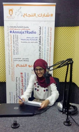 In this undated photo, Sara Momani broadcasts live from  Radio Annaja7 (Photo courtesy of UNESCO)