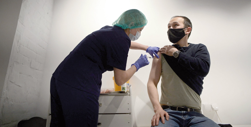 A healthcare worker administers a dose of Russia's Sputnik V COVID-19 vaccine to a patient at a vaccination centre in the GUM, State Department store in Moscow, on Friday (AFP photo)