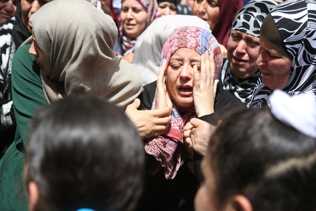 Relatives of Casim Mohammed Nahli (17), who was killed by Israeli forces, mourn during a funeral ceremony at a refugee camp in Ramallah, West Bank, on Tuesday (Anadolu Agency photo)