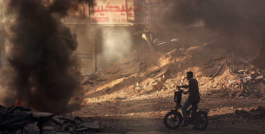 A Palestinian man stands in a devastated street near tyres set ablaze by youths in Jenin in the occupied West Bank on September 4, 2024, during an ongoing Israeli military raid (AFP photo)