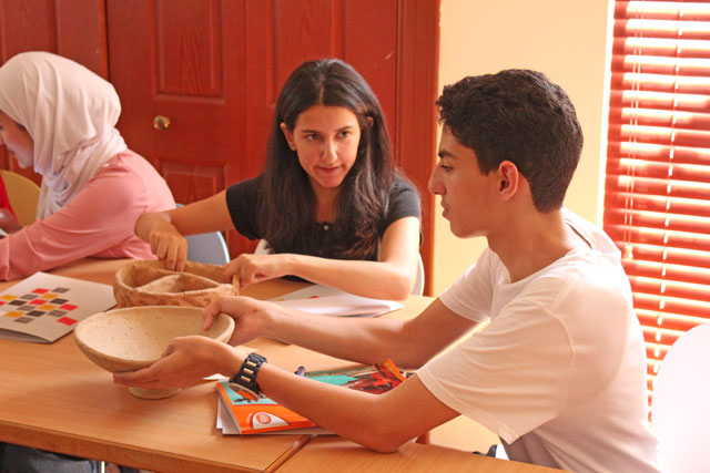 High school students analyse pottery at the workshop organised at the GPIA last week (Photo courtesy of the GPIA)