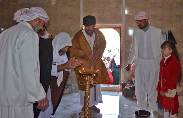 Iraqi Yazidis visit their temple during a ceremony on Friday, in the town of Bashiqa, some 20 kilometres northeast of Mosul (AFP photo)