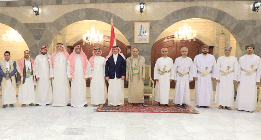 This handout photo released by the Houthi-affiliated branch of the Yemeni News Agency SABA on Sunday, shows the Houthi group's political leader Mahdi Al Mashat (6th right) posing for a photo with the Saudi Ambassador to Yemen Mohammed Al Jaber (7th left) and a delegation, alongside an Omani delegation in Sanaa (AFP photo)