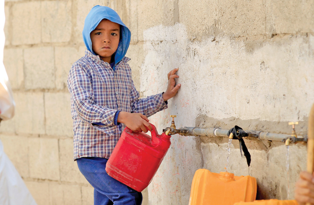 A Yemeni child fills his jerrycan with drinking water from a donated tank amid acute shortage in the capital Sanaa on Thursday (AFP photo)