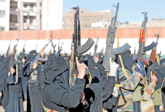Women loyal to the Houthi movement hold up rifles as they attend a gathering to show support to the movement in Sanaa, Yemen, on Monday (Reuters photo)