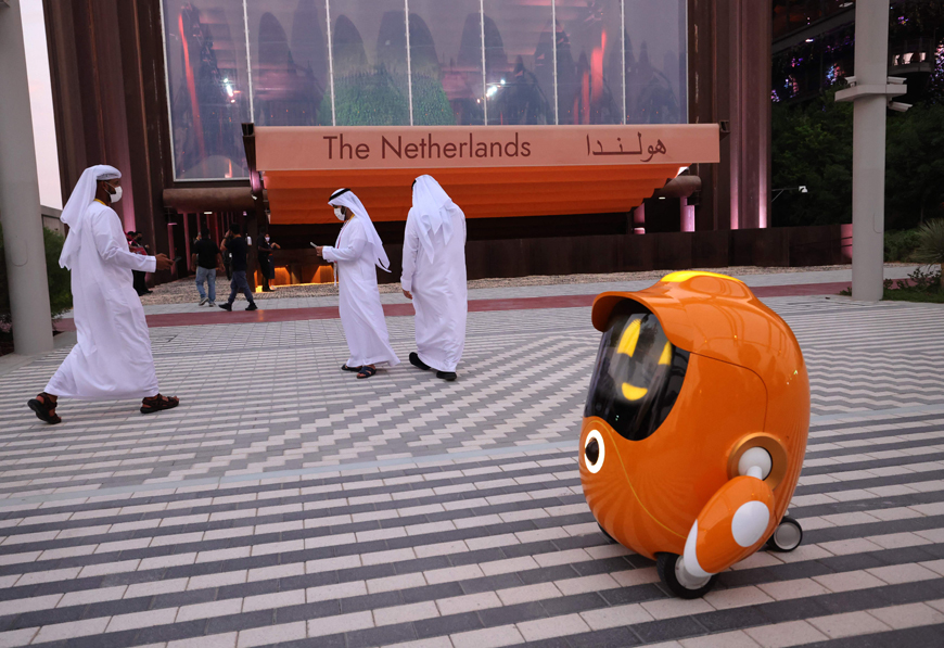 In this file photo taken on October 2, visitors walk past a robot outside the Dutch pavilion at the Expo 2020, in the Gulf Emirate of Dubai (AFP photo)